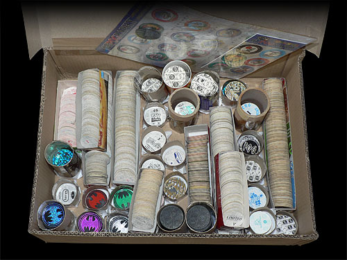 Photo of a box full of Pog swaps, stored in Pogtainers and Pog trays